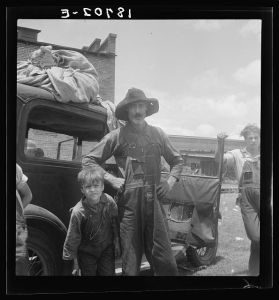Douglas, Georgia. South Georgia tobacco sharecropper in town for auction. Note tobacco sheets in which he brought tobacco from the farm