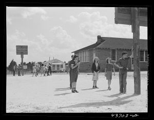 The white schoolhouse in the background was erected by Hazlehurst Farms Inc. to accommodate the increased enrollment as a result of families moving into prefabricated houses