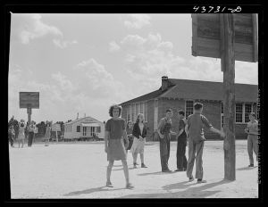 [Untitled photo, possibly related to: The white schoolhouse in the background was erected by Hazlehurst Farms Inc. to accommodate the increased enrollment as a result of families moving into prefabricated houses]