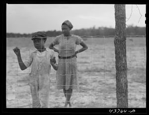 [Untitled photo, possibly related to: Two of the Negro people who have been moved out of the Camp Stewart area near Hinesville to Hazlehurst Farms. Hazlehurst, Georgia]