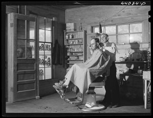 [Untitled photo, possibly related to: Mr. J. H. Parham, barber and notary public, in his shop in Centralhatchee, Heard County, Georgia]