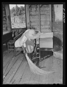Daughter of Mr. Frank Champion, FSA (Farm Security Administration) borrower, sweeping up. Near White Plains, Greene County, Georgia