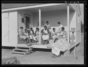 Home economics and home management class for adults, under supervision of Miss Evelyn M. Driver (standing in white uniform). Everything they make including the small handmade looms, utilizes materials of local origin as cornshucks, cane, flour and meal and feed sacks, etc. Flint River Farms, Georgia