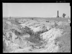 Soil erosion and remaining chimney of house. Greene County, Georgia