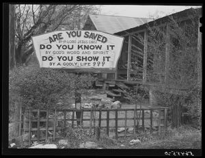 Religious sign in front of house on highway between Columbus and Augusta, Georgia. Similar religious signs were placed along this highway at intervals of at least a mile and often much closer together