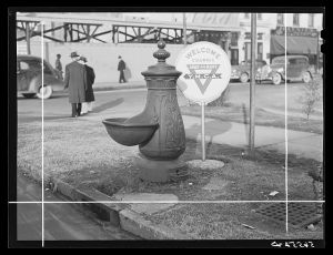 Water trough and Y.M.C.A. (Young Mens Christian Association) welcome sign in square in center of town.  Columbus, Georgia