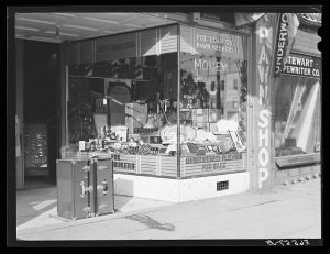 Pawn shop with trunks and boots displayed on main street in Columbus, Georgia