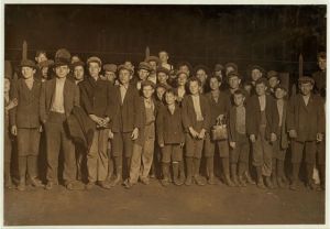 6:00 P.M. Flashlight photo of part of force going home. Sibley Mfg. Co. Augusta, Ga. Some of the smallest boys said been in mill from one to several yrs. Jan. 15, 1909. Location: Augusta, Georgia.