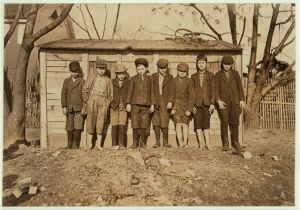 Sunday. Boys working in Bibb Mill #1, Macon, Ga. Tallest boy on right hand end (with cap) Grady Olford, been in mill work 5 years. Next, Claudie Bonner. Next, Willie Dix. Next Hermie Allen been in mill work 5 years. Bobbie Dix been in mill work 4 years. Next Alton Wright, been in mill work 1 year. Next David Bonner. (Left hand end shortest boy.) Albert Bowman nearly 4 years in mill. Witness Sara R. Hine. Location: Macon, Georgia.