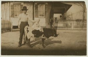 2 "yearlings" belonging to a South Georgia farmer. The former usually gets more attention than the child. John Paulk family. See report of Lewis W. Hine on Georgia, March 1915. Location: Kirkland, Georgia.