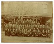 Photograph of men standing in front of the Northeastern Banking Co. building, Commerce, Georgia