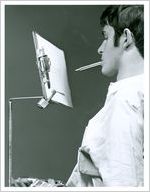 Photograph of a male patient writing on a clipboard with a pencil held in his mouth at the Georgia Warm Springs Foundation, Warm Springs, Meriwether County, Georgia, 1959