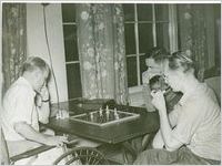 Photograph of two male patients playing chess in Georgia Hall at the Georgia Warm Springs Foundation, Warm Springs, Meriwether County, Georgia, 1939-1949?