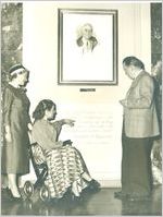 Photograph of actress Helen Hayes, singer Connie Boswell, and president of the Georgia Warm Springs Foundation Basil O'Connor pause to read the inscription beneath a copy of the unfinished portrait of Franklin Delano Roosevelt in Roosevelt Hall at the Georgia Warm Springs Foundation, Warm Springs, Meriwether County, Georgia, 1949-1959?