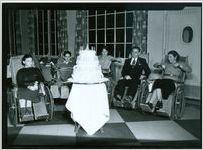 Photograph of five patients gathered around a birthday cake prepared for one of the President's Birthday Ball fundraising celebrations at the Georgia Warm Springs Foundation, Warm Springs, Meriwether County, Georgia, 1932-1941?