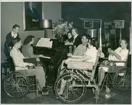 Photograph of patients participating in a sing-a-long around the piano in Georgia Hall at the Georgia Warm Springs Foundation, Warm Springs, Meriwether County, Georgia, 1945-1955?
