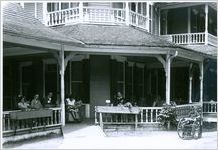 Photograph of a group of patients relaxing on the porch of the Meriwether Inn at the Georgia Warm Springs Foundation, Warm Springs, Meriwether County, Georgia, 1927-1934?