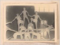 Photograph of boys forming a human pyramid during a physical education class at Screven County High School, Sylvania, Georgia, 1951