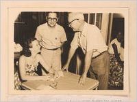 Photograph of a public health clerk collecting information from men about to receive a health test, Sylvania, Georgia, 1951