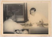 Photograph of men discussing results of a public health test, Sylvania, Georgia, 1951