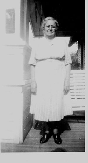 An older woman standing in a door way