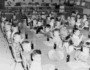 Unidentified CEA Kindergarten students and staff each with a bottle of Coca-Cola (Coke), at a class party