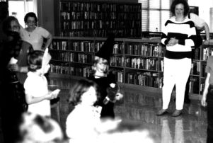 Adults with children in costume at Coleman Library