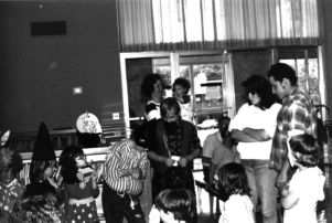 Adults with children in costume at Coleman Library