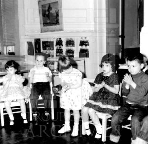Five CRA Kindergarten, identities unknown, seated in classroom.