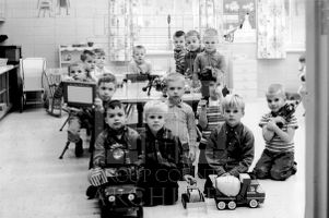 CEA Kindergarten male students, identities unknown, in classroom with toy truck