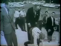 JUMPING FROG ON STEPS OF OFFICE BUILDING (NO DATE)