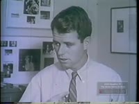 ROBERT KENNEDY EXAMINES DOCUMENTS PLACED IN CARDBOARD BOX