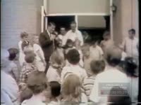 TWO LITTLE GIRLS EATING HOTDOGS ARE PHOTOGRAPHED BY NEWSMEN