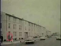 WSB-TV newsfilm clip of white women driving Daisy Gabrielle and her first grade daughter, Yolanda, to the newly integrated William Frantz Public School; white demonstrators protesting the school's integration; and cars parked in a parking lot in New Orleans, Louisiana, 1960 November or December
