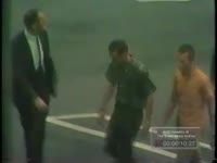 MEN IN HANDCUFFS, OTHERS WITH GUNS, MEN IN CLASSROOM, DISCUSSION OF LAWMAN'S KNOWLEDGE OF AUTO THEFT
