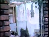 FIREMEN EXPLORE A BUILDING GUTTED BY FIRE