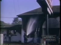 FIREMEN EXAMINE BURNT HOUSE