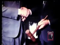 TWO ELDERLY MEN EXCHANGE GAVEL
