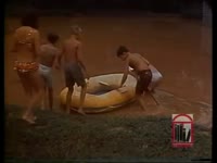 Young students play in large puddle caused by heavy rains and flooding.