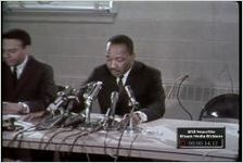 Martin Luther King Jr., at a press conference held at Ebenezer Baptist Church in Atlanta, Georgia, discusses his lack of interest in a potential independent candidacy for political office, the escalation of the Vietnam War, the Black Panthers, and Stokely Carmichael (footage continued on next reel).