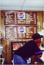 Mexican and "American" product signs inside Jones Country Meats