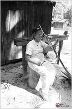 Bernice Roddenberry and daughter Debbie Todd gatherspalmetto fronds into three sections from PHO-BW-1997