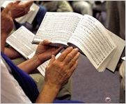 Ramona Lee beats time as she sings from the revised Cooper edition of BF White's Sacred Harp during a monthly sing at the Hoboken Elementary School Photo by Laurie Kay Sommers