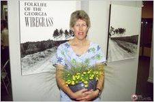 Laurie Sommers holds a pot of wiregrass at the opening of Folklife of Wiregrass Georgia exhibit