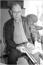 Bud Zorn poses with his homemade fiddle replicas of his first instruments