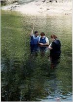 Elder Clarke Lee baptizes Julie  Lee in Satilla River as Kathy Lee looks on
