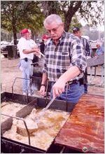 Bainbridge fire chief Dennis Mock fries suckerfish for the plate meals at the festival