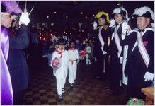 Youngster dressed as Juan Diego processes between the Knights of Columbus for the Fiestas Guadalupanas