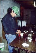 Capping bottles of cane syrup (CS-199716